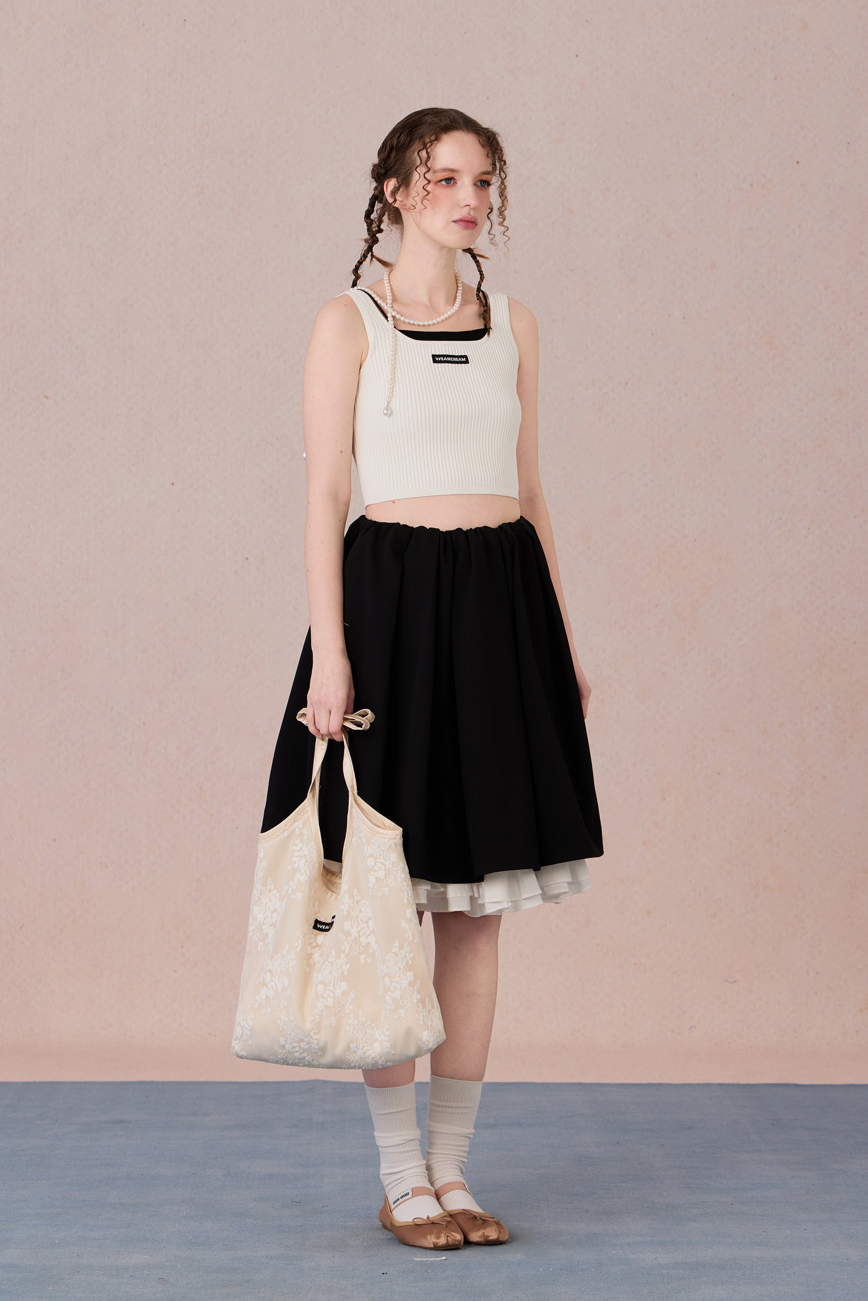 Sleeveless black and white layering-effect tank styled under a blazer