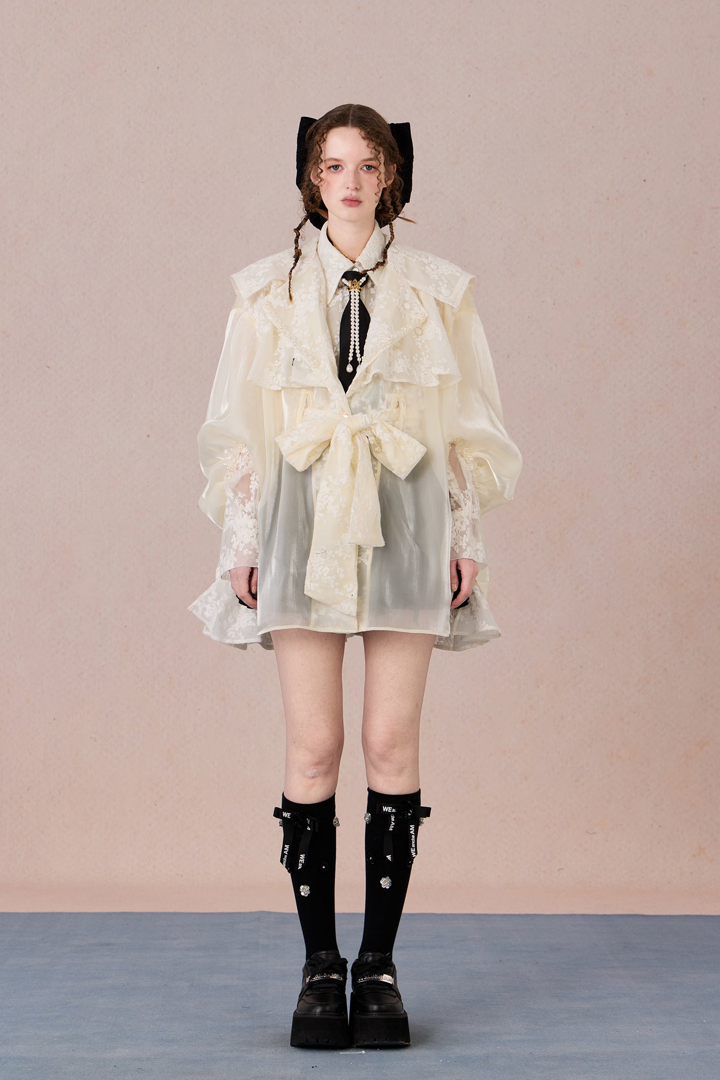 Lightweight romantic layering piece with beaded detailing and structured collar