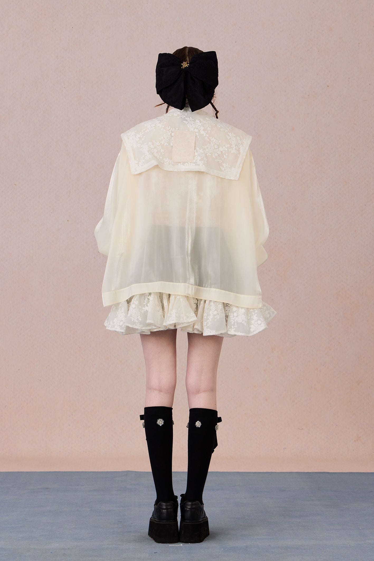 Ruffled hem chiffon jacket with lace appliqué and soft pearl luster