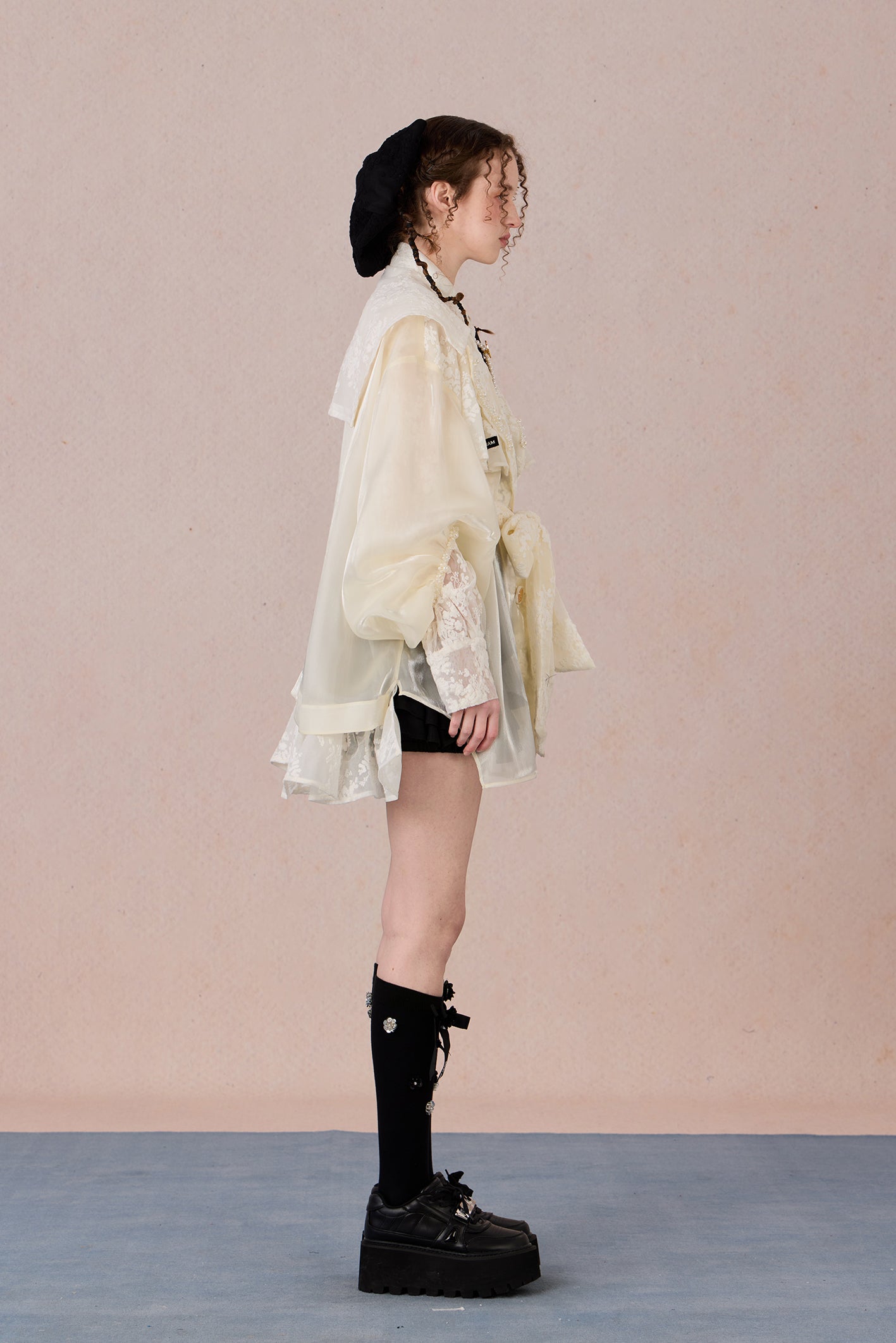 Lightweight romantic layering piece with beaded detailing and structured collar