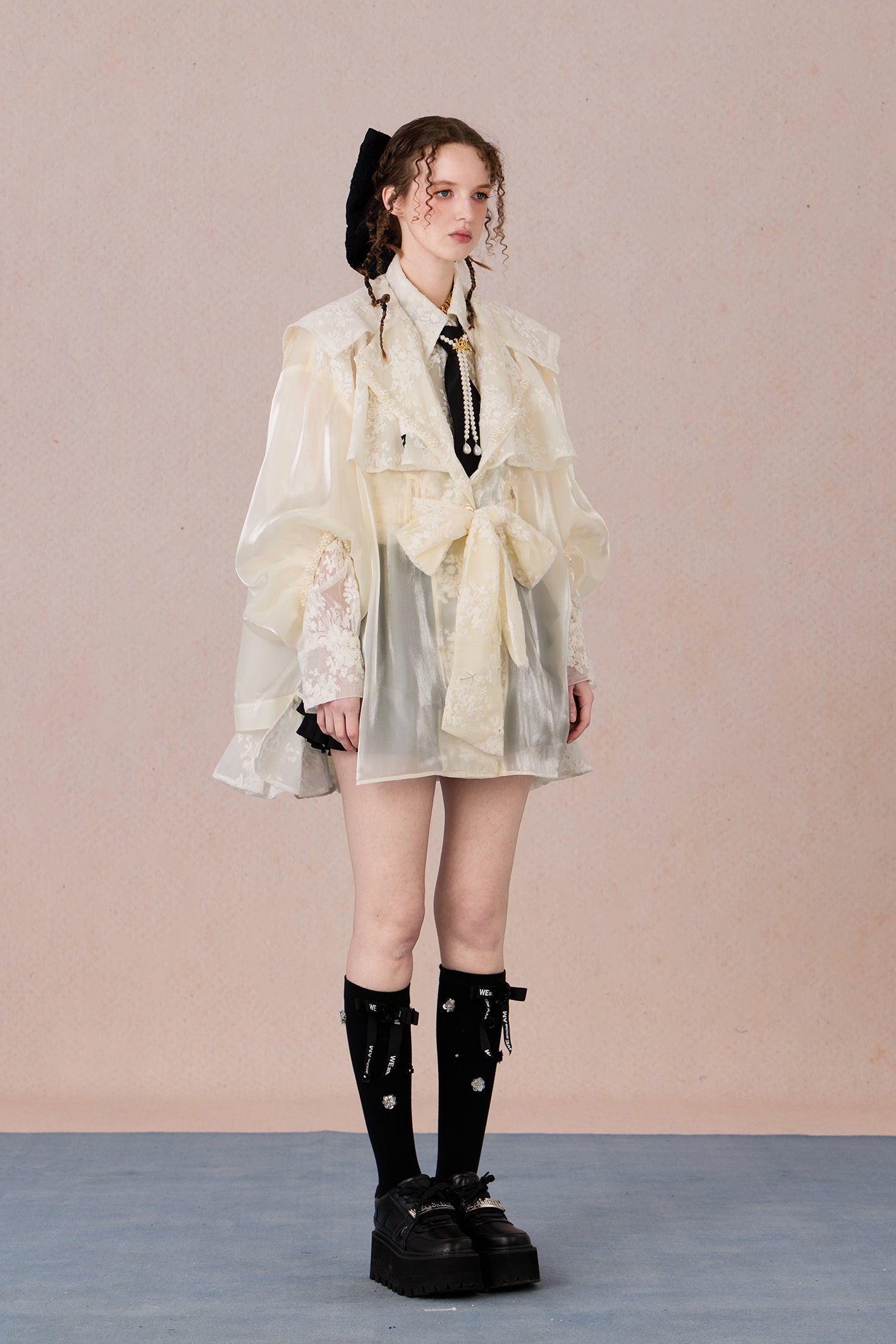Lightweight romantic layering piece with beaded detailing and structured collar