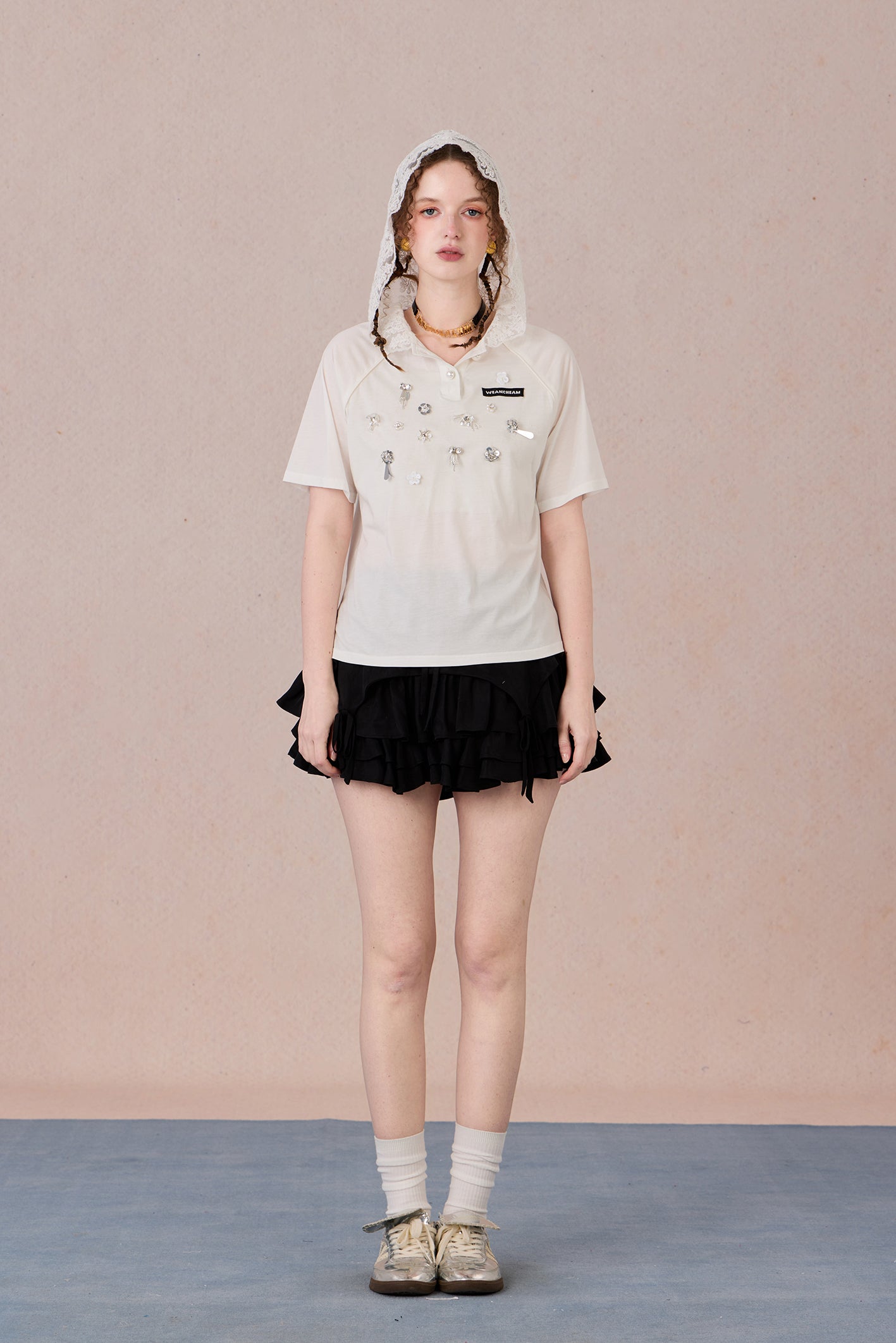 Feminine short sleeve embellished tee with soft drape and casual elegance