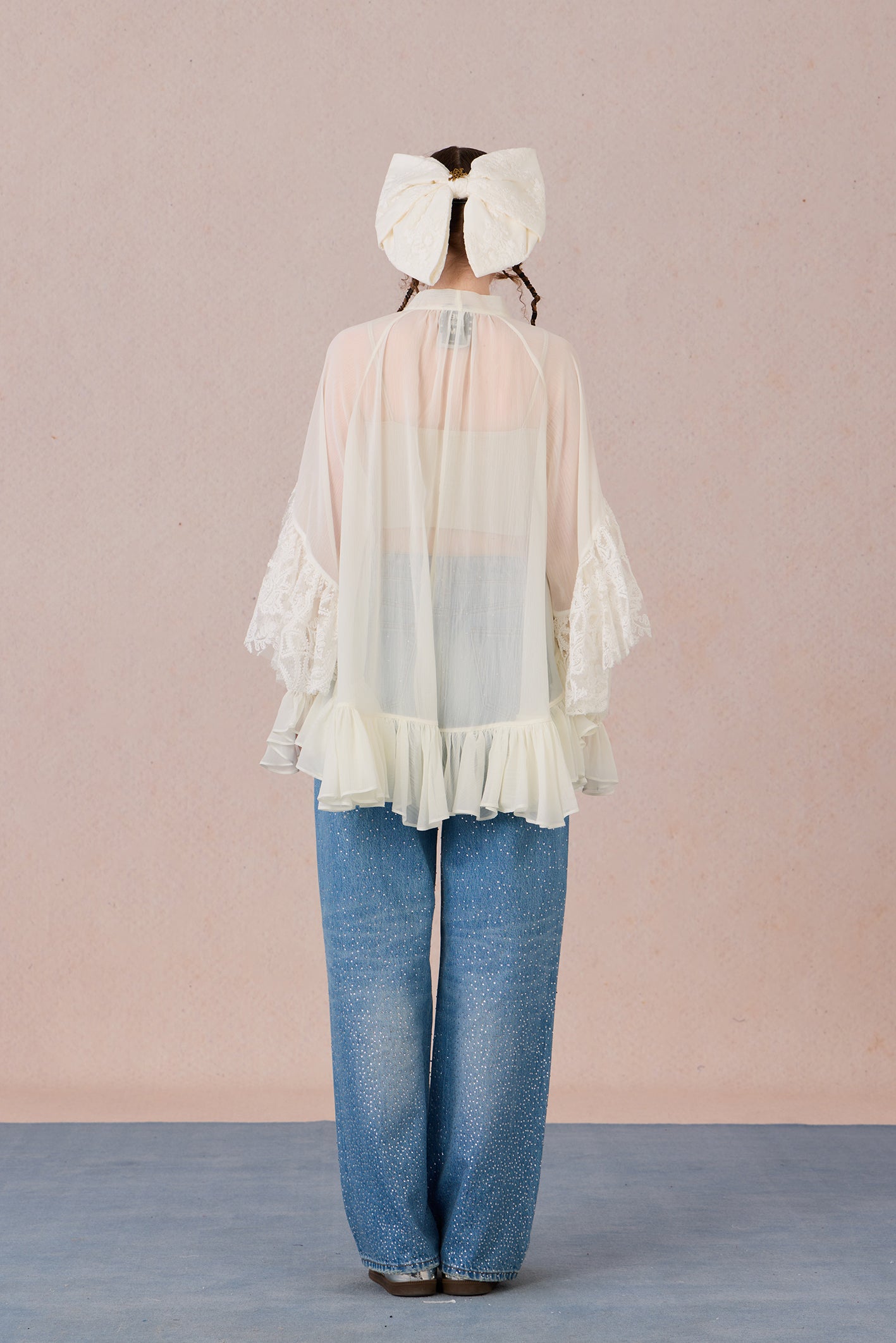 Sheer romantic blouse with flowing silhouette and tulle texture