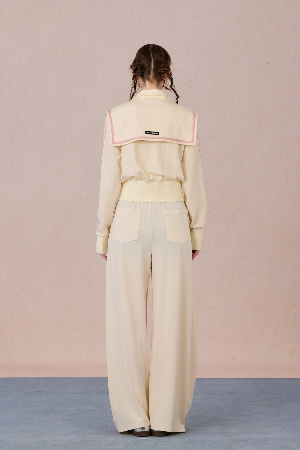  Back view of tailored color-block jacket with fitted waistline and sporty trim