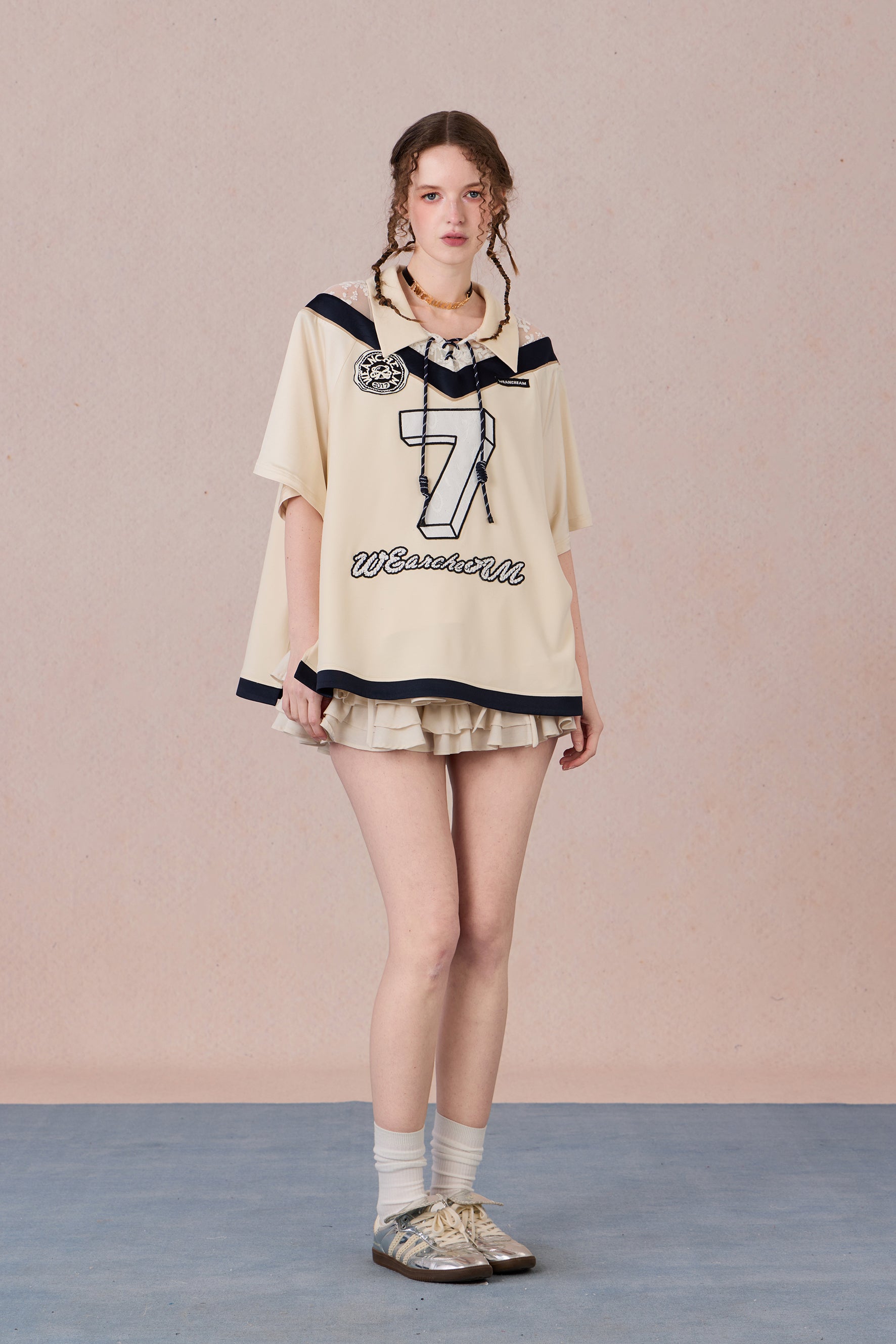 Feminine streetwear tee with mesh panels and loose fit