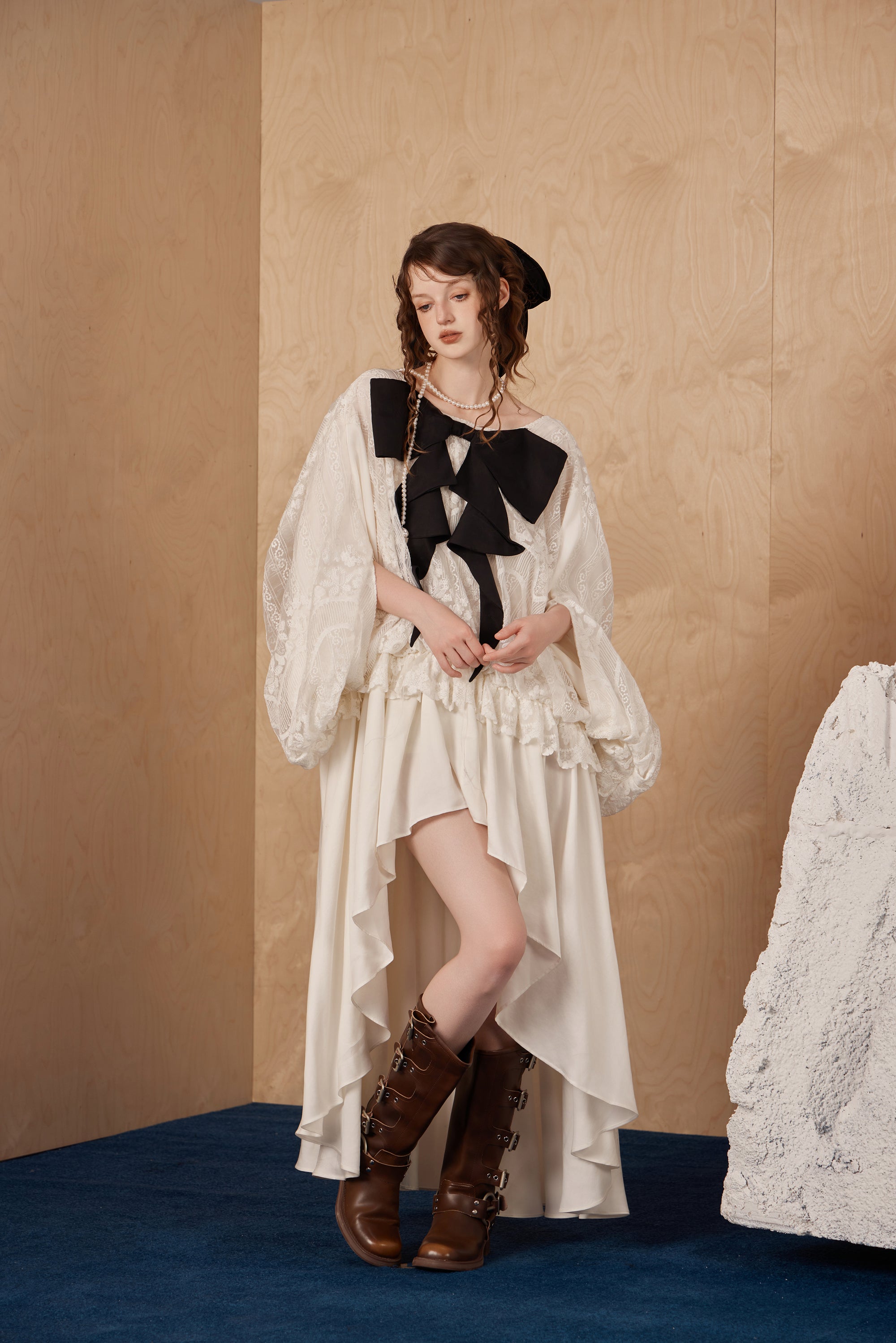 Model wearing romantic long ribbon bow dress with draped fabric