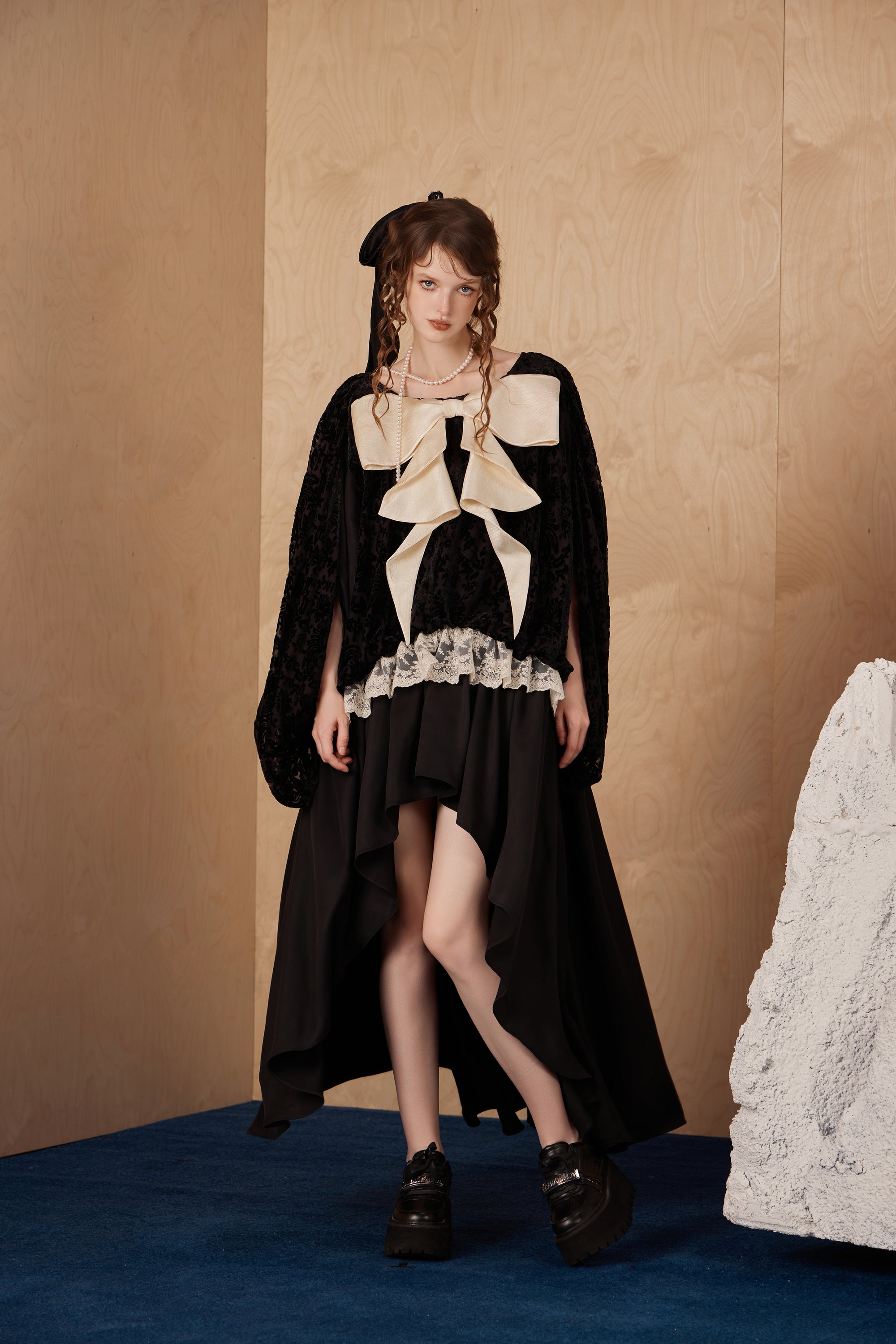 Model wearing romantic long ribbon bow dress with draped fabric