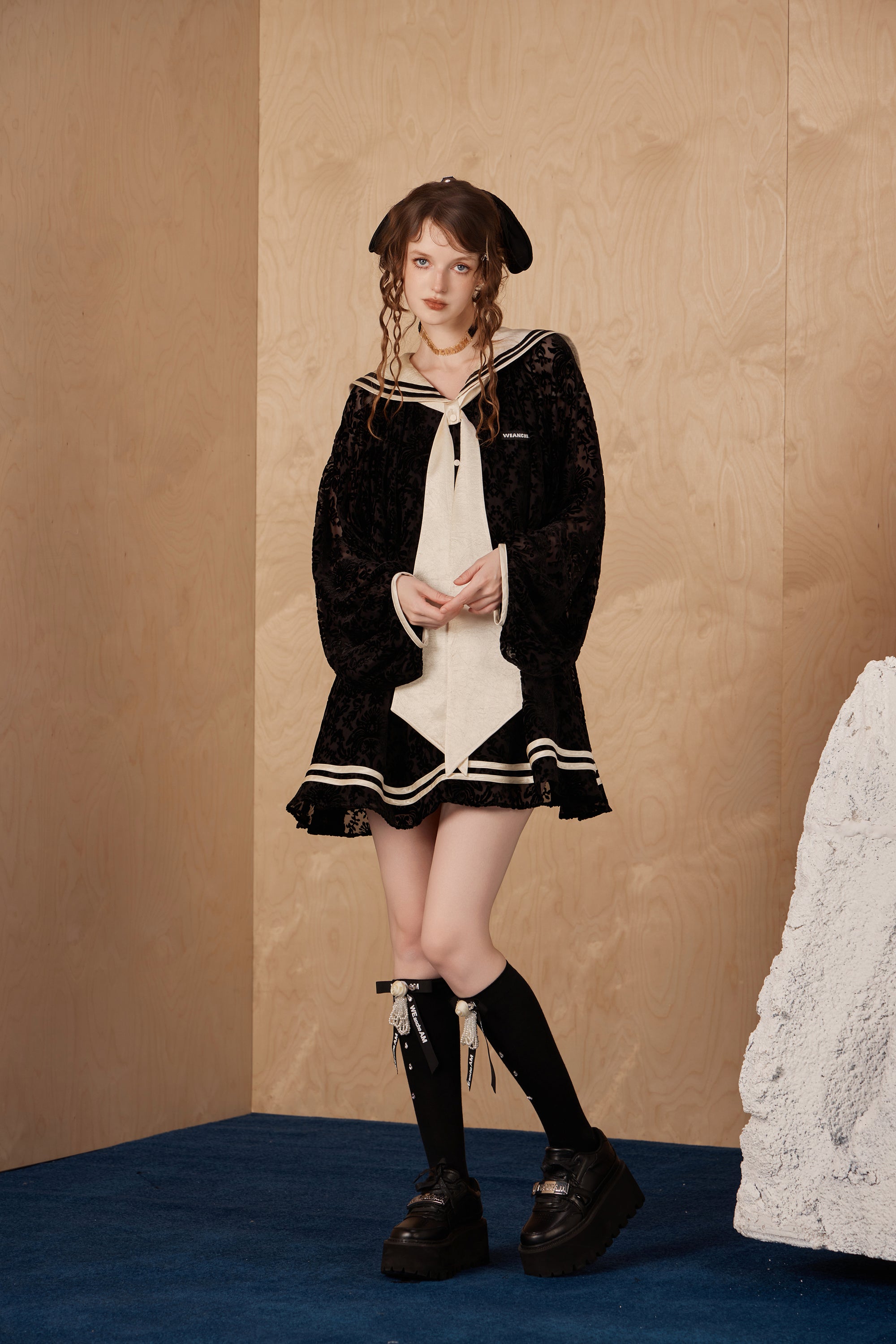 Model wearing elegant navy collar ribbon dress with flowing A-line hem