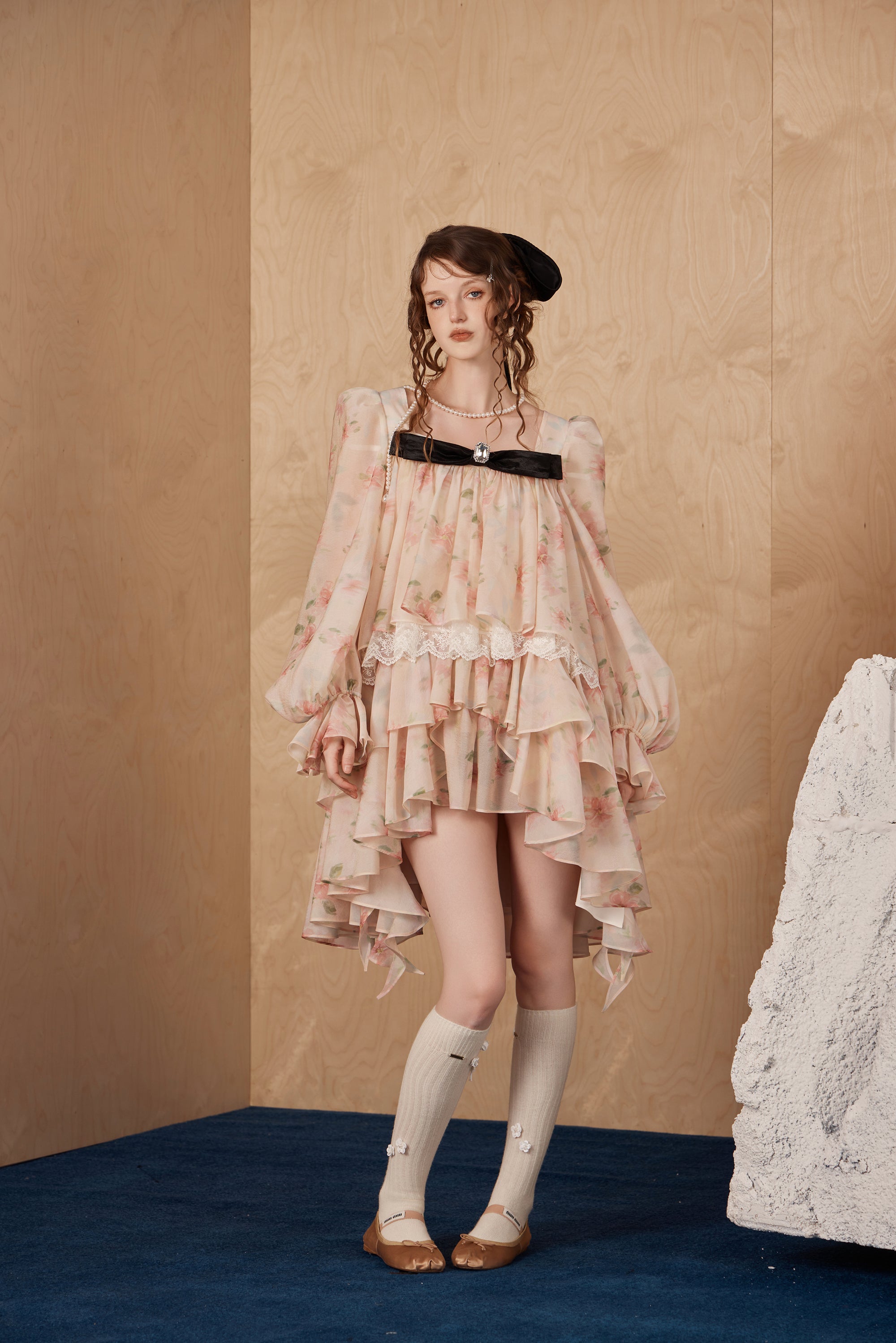 Model wearing layered bubble sleeve dress with semi-sheer fabric and vintage charm