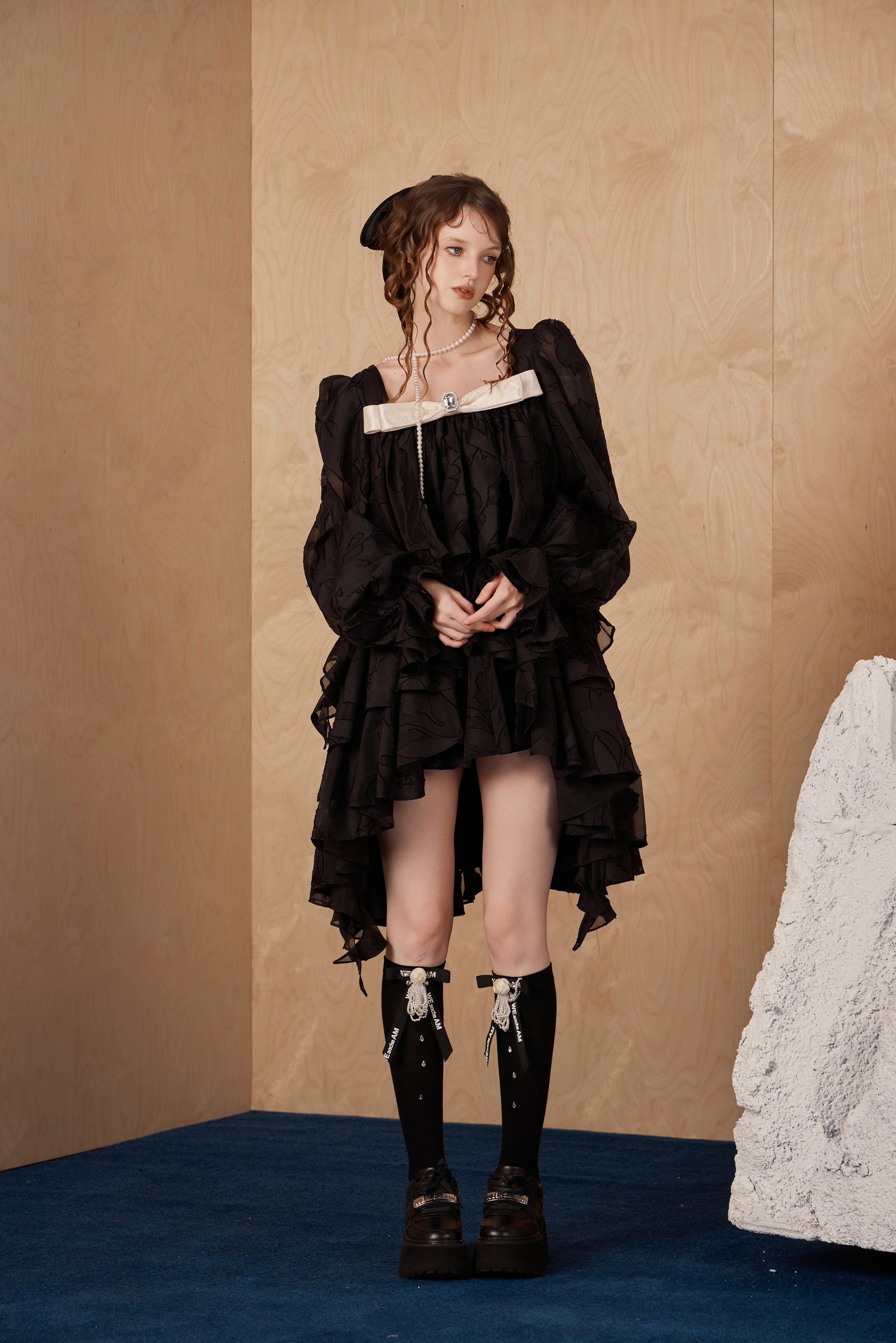 Model wearing layered bubble sleeve dress with semi-sheer fabric and vintage charm