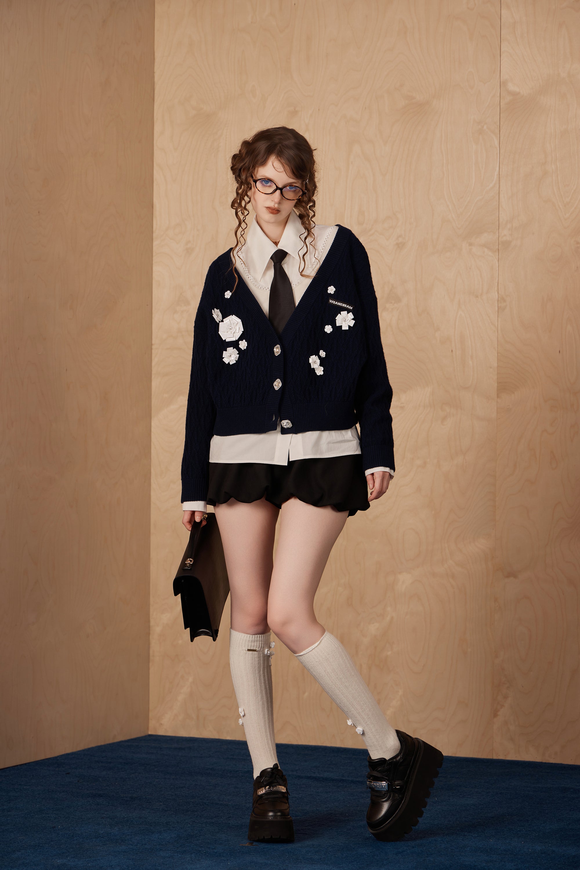 Model wearing merino wool beaded faux two-piece knit cardigan