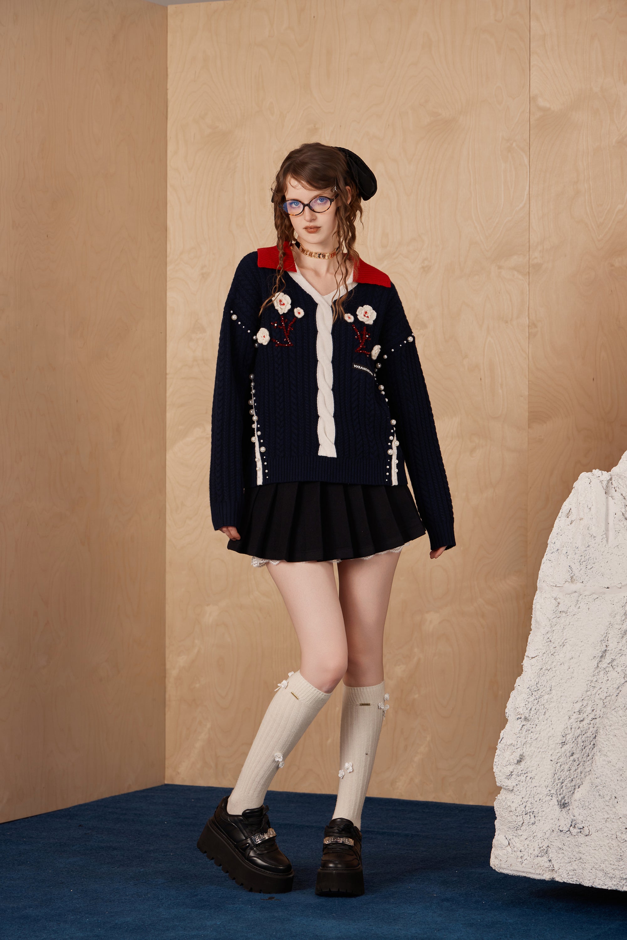Model wearing double waistband pleated skirt with lace-trim hem and relaxed fit