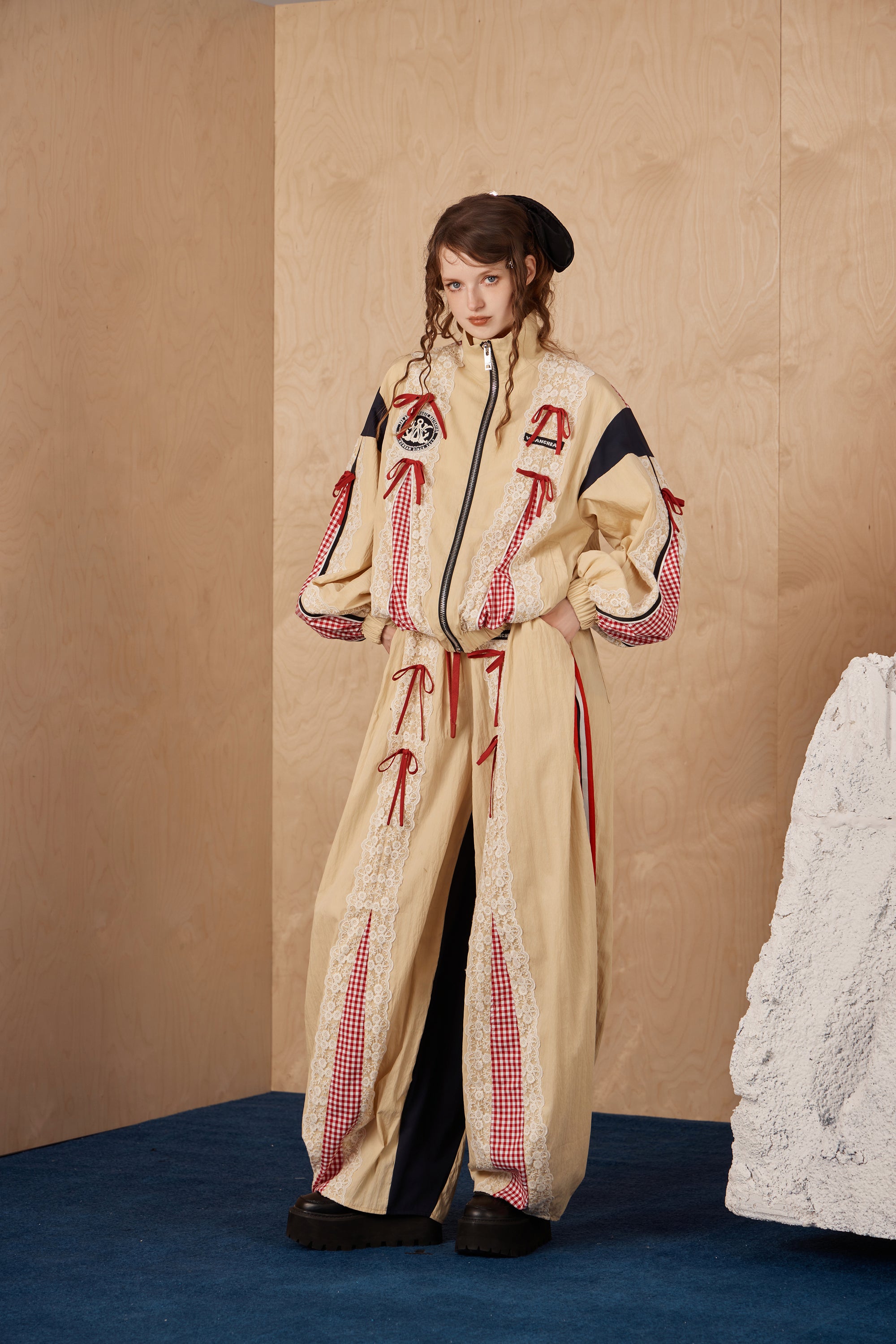Model wearing lace bow patchwork pants with cotton-nylon blend fabric