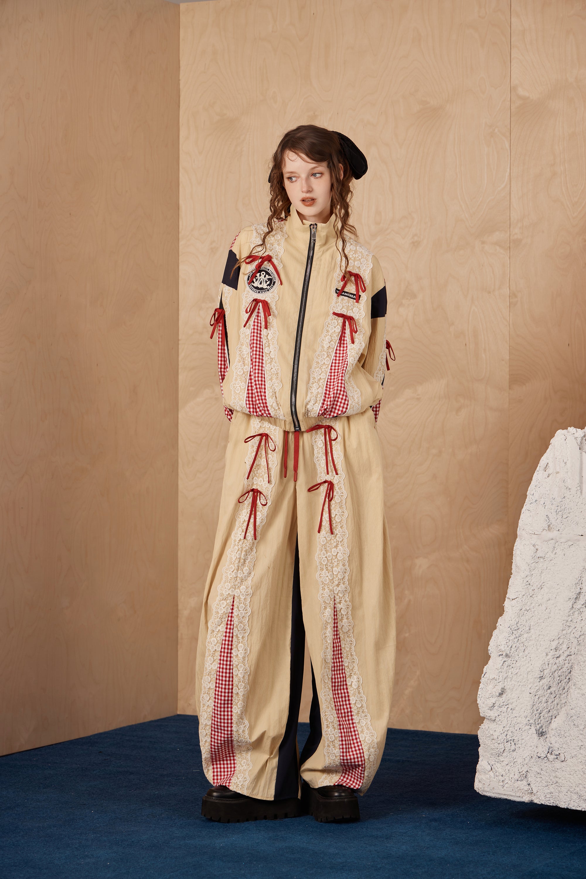 Model wearing lace bow patchwork jacket with color-blocking and cotton-nylon comfort