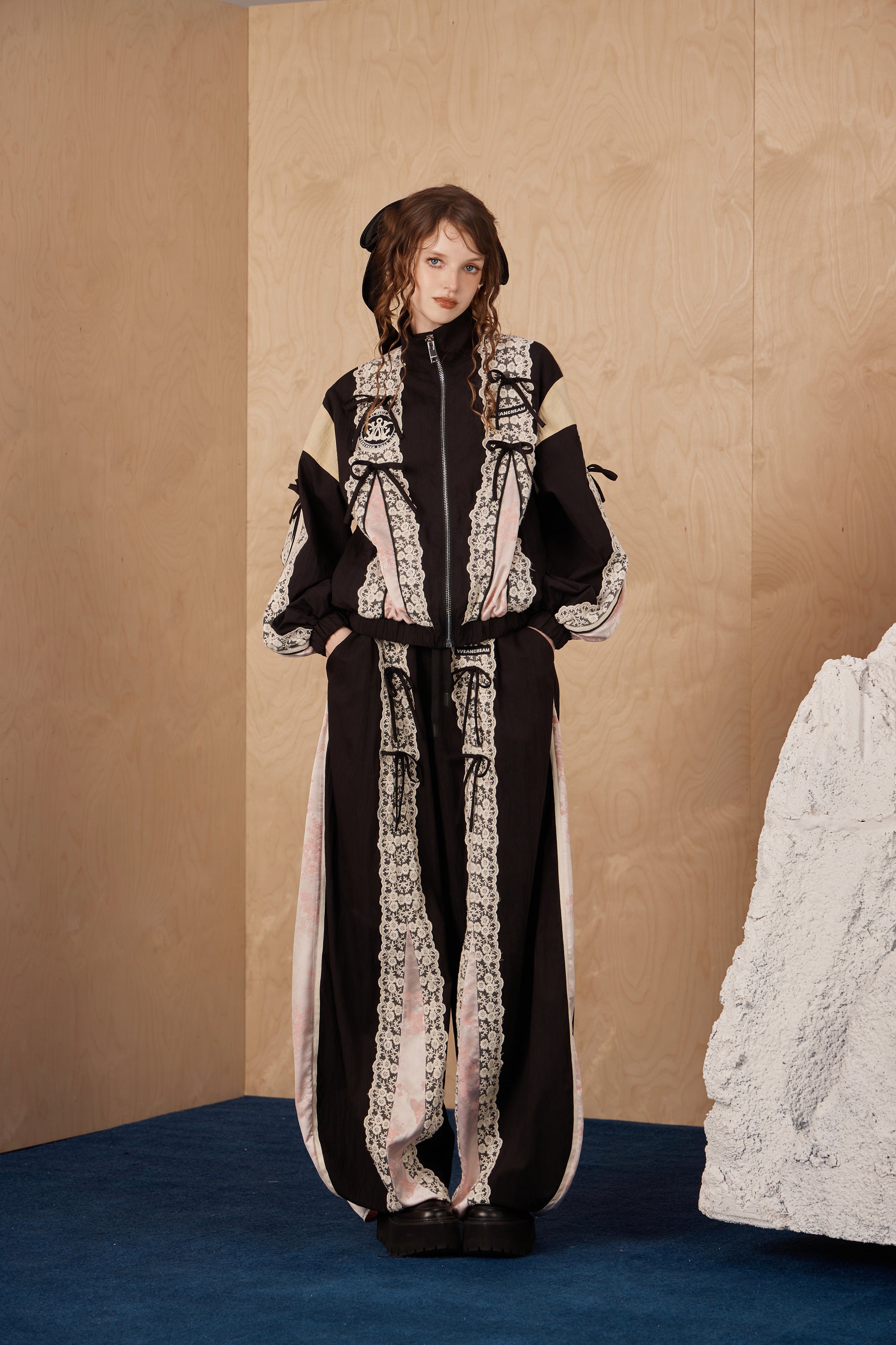 Model wearing lace bow patchwork jacket with color-blocking and cotton-nylon comfort