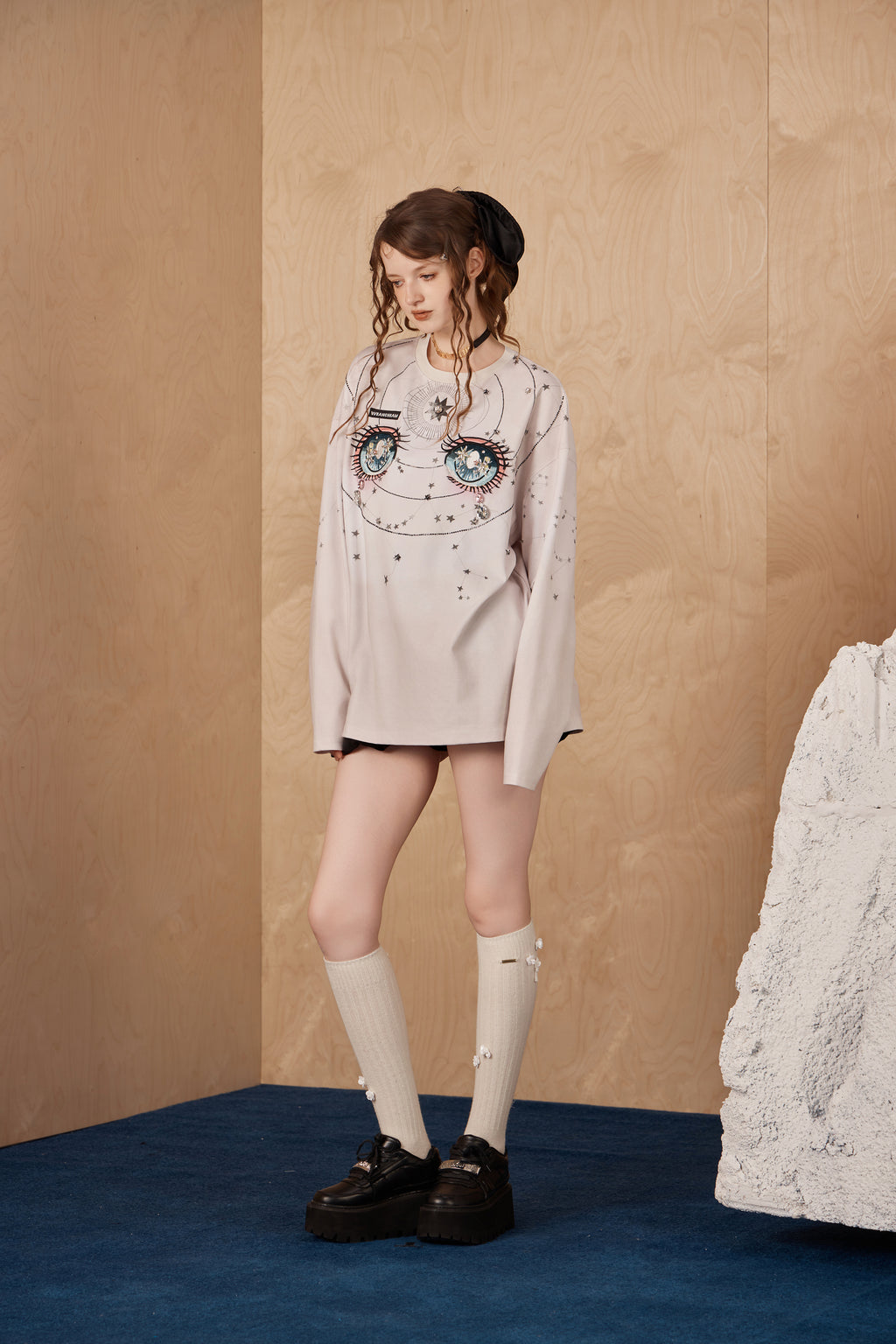 Model wearing constellation-inspired rhinestone long-sleeve T-shirt with embroidered label