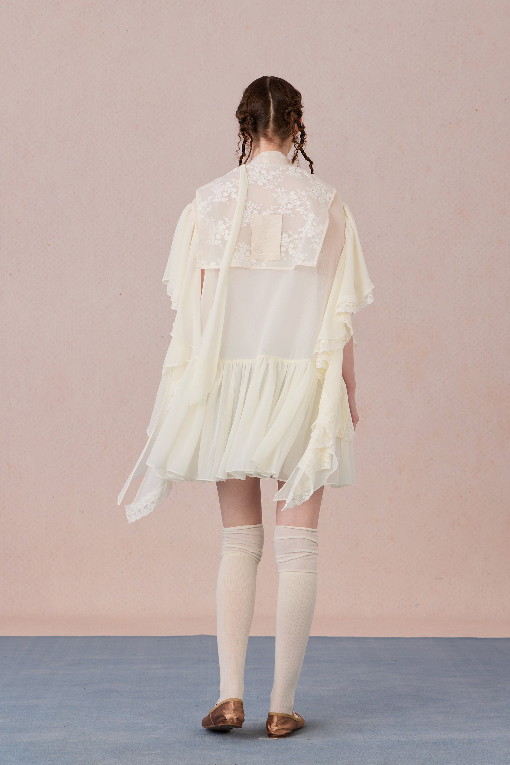 Back view of pastel chiffon spring dress with airy layered skirt
