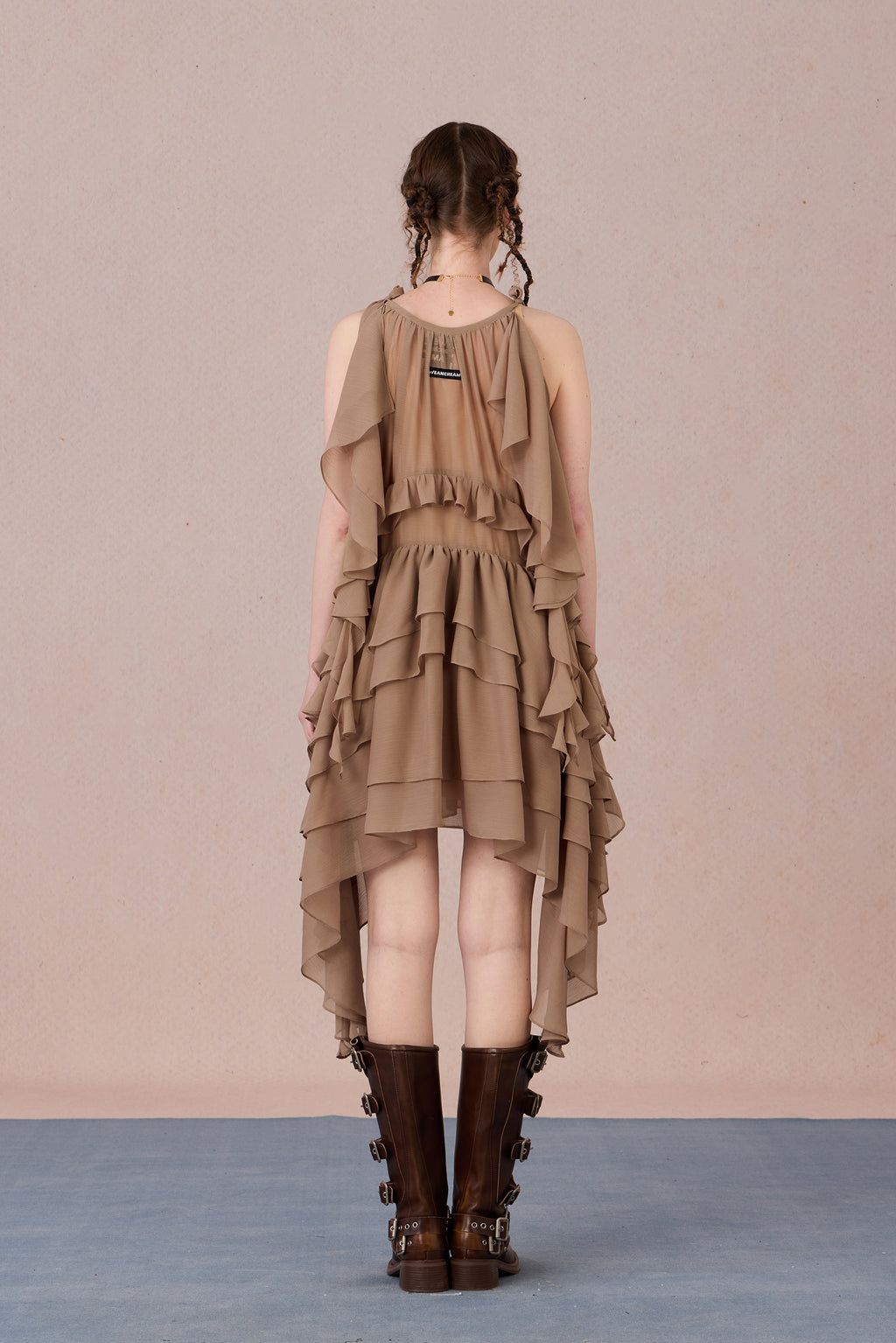 Close-up of three-dimensional beaded bow and irregular lace hem