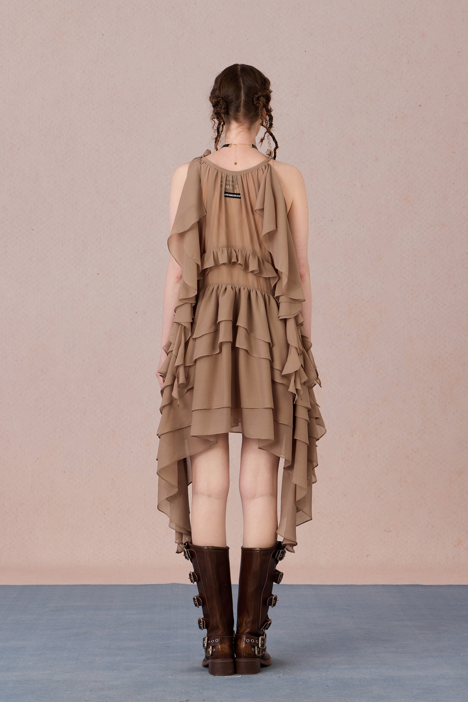 Close-up of three-dimensional beaded bow and irregular lace hem