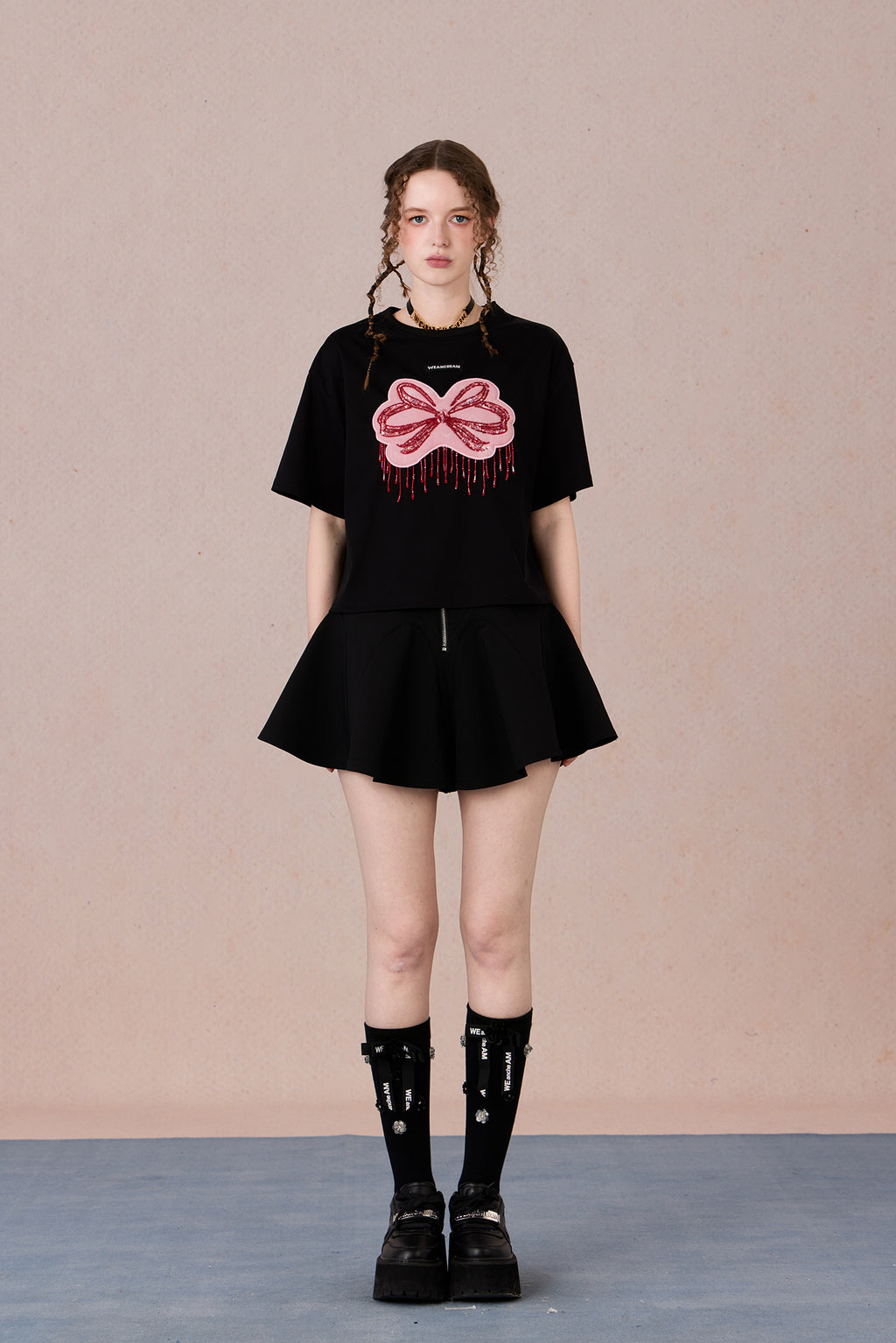 Loose fit round neck tee with bold red hand-beaded bow design