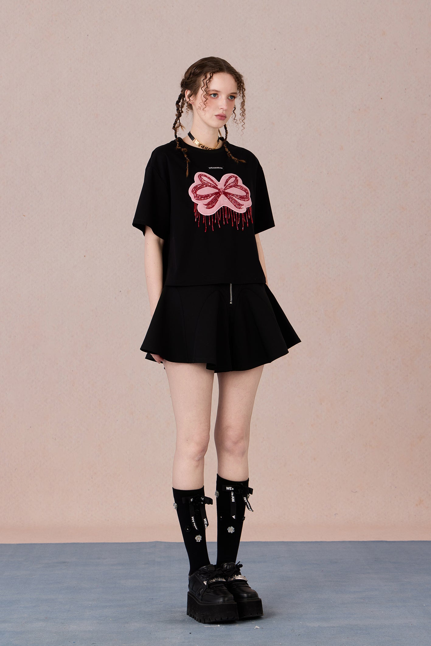 Loose fit round neck tee with bold red hand-beaded bow design