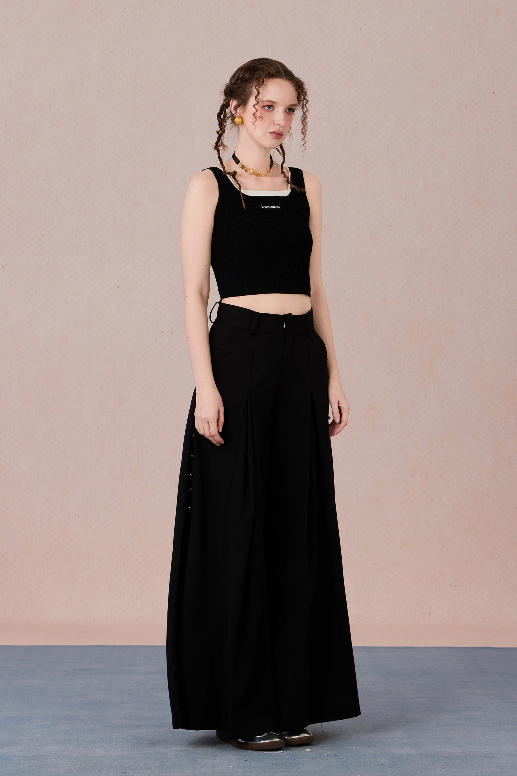 Sleeveless black and white layering-effect tank styled under a blazer
