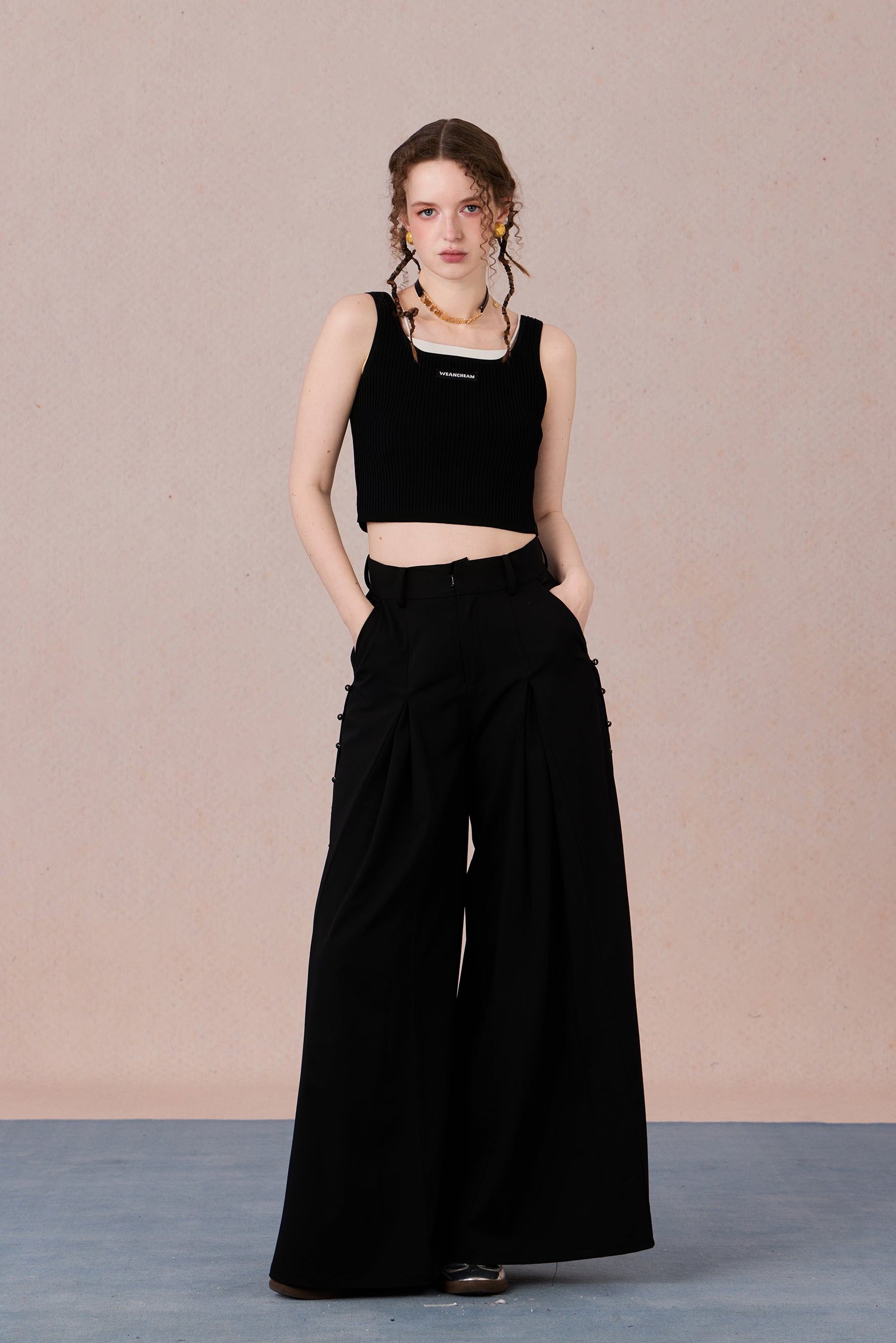 Sleeveless black and white layering-effect tank styled under a blazer