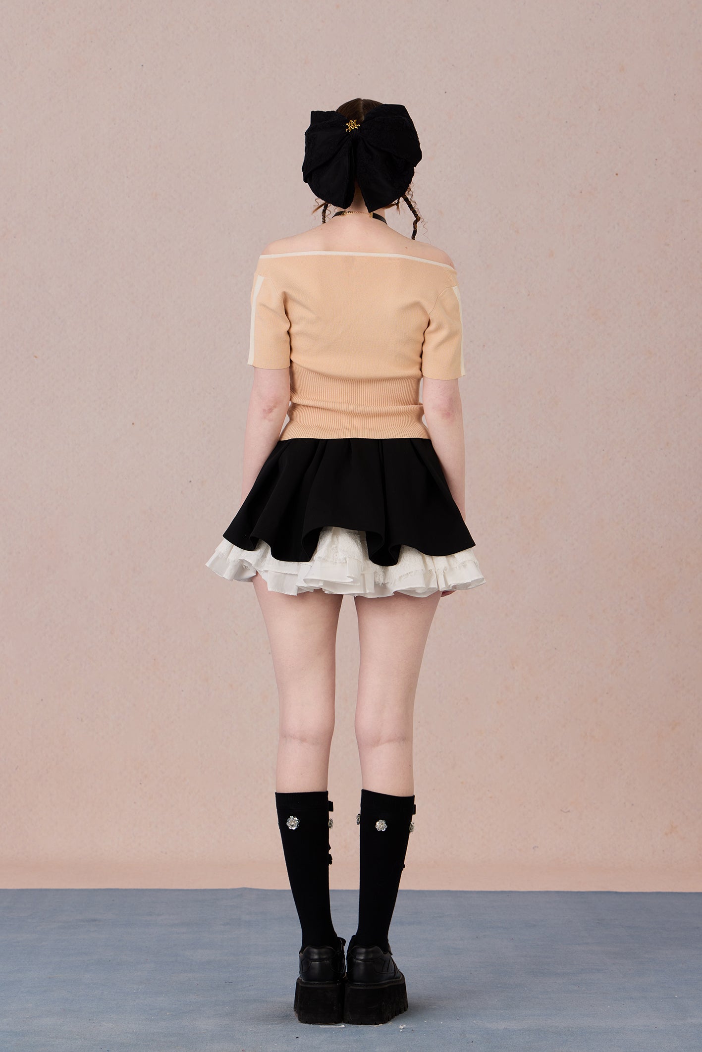 Slim bow tie top styled with trousers for evening wear