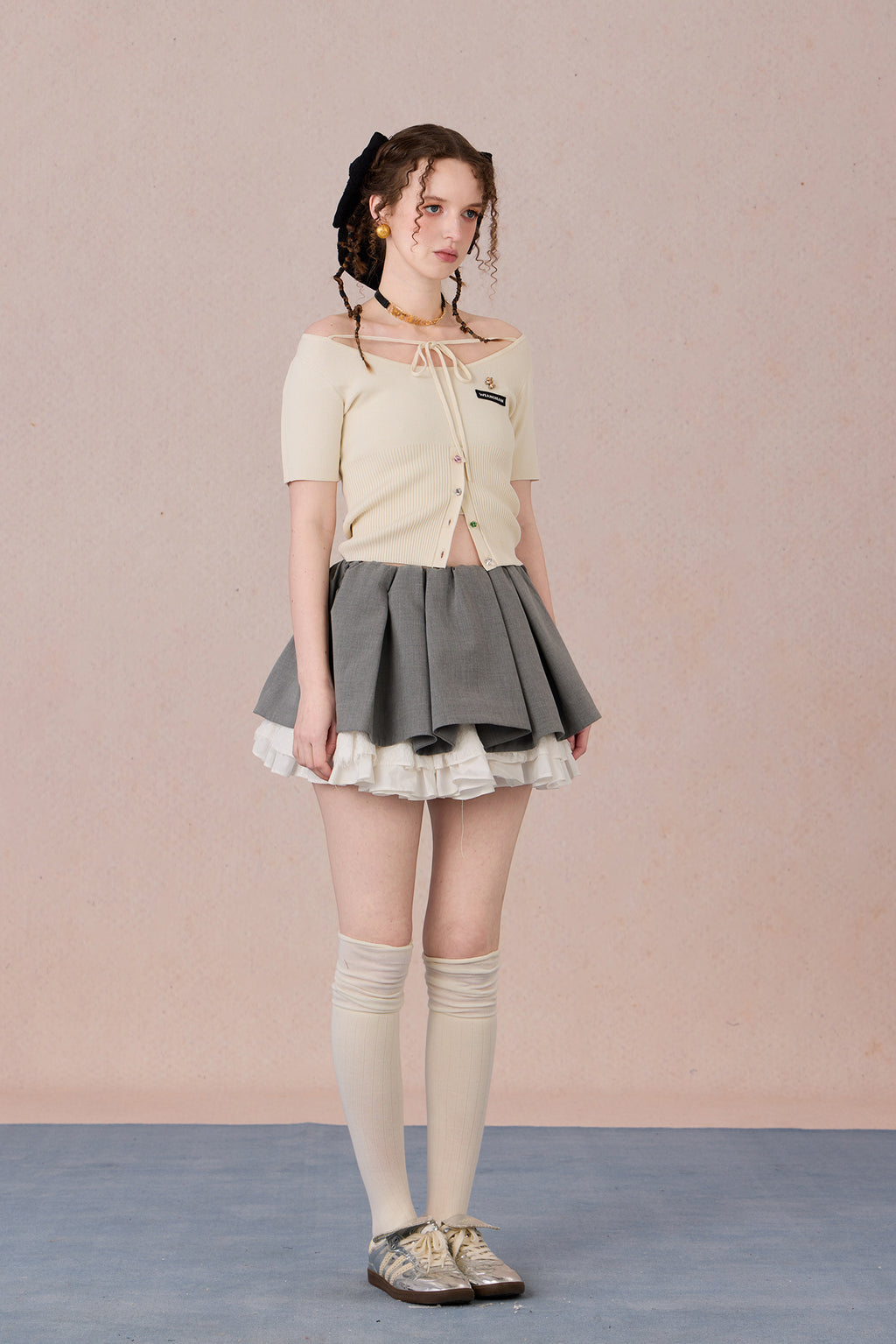 Slim bow tie top styled with trousers for evening wear