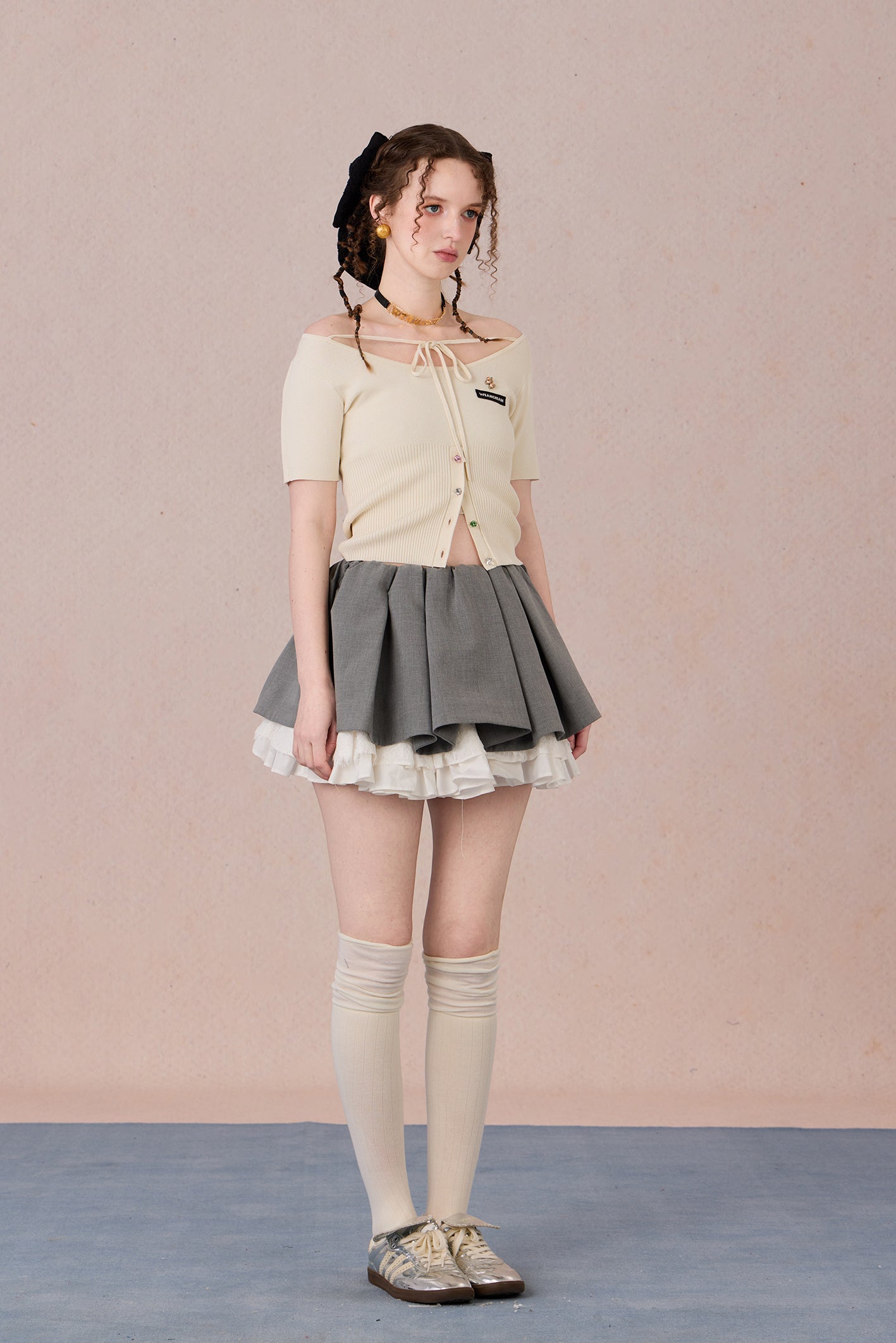 Slim bow tie top styled with trousers for evening wear