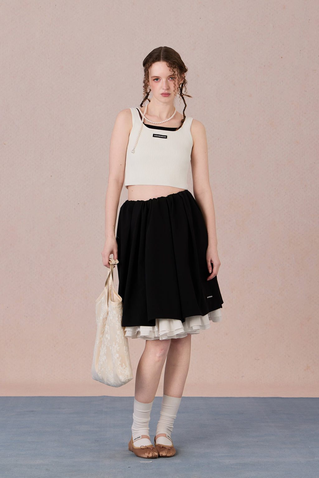 Sleeveless black and white layering-effect tank styled under a blazer