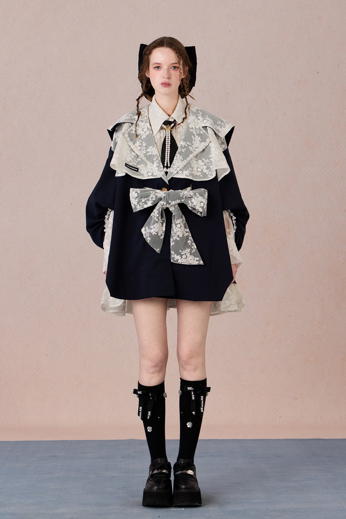 Lightweight romantic layering piece with beaded detailing and structured collar