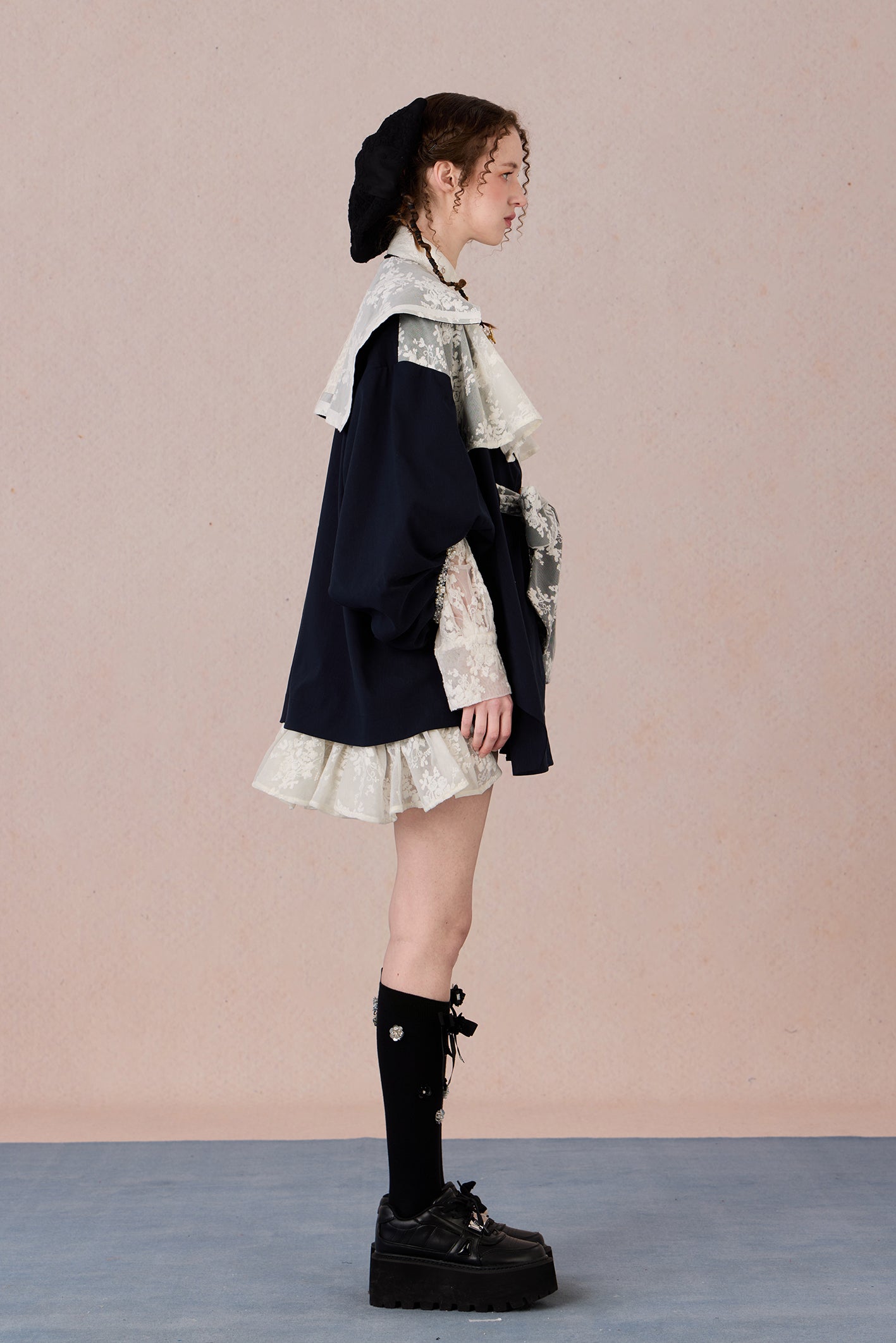 Lightweight romantic layering piece with beaded detailing and structured collar