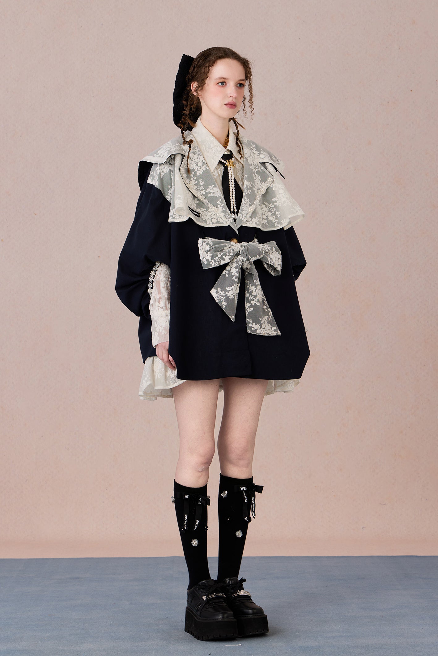 Lightweight romantic layering piece with beaded detailing and structured collar