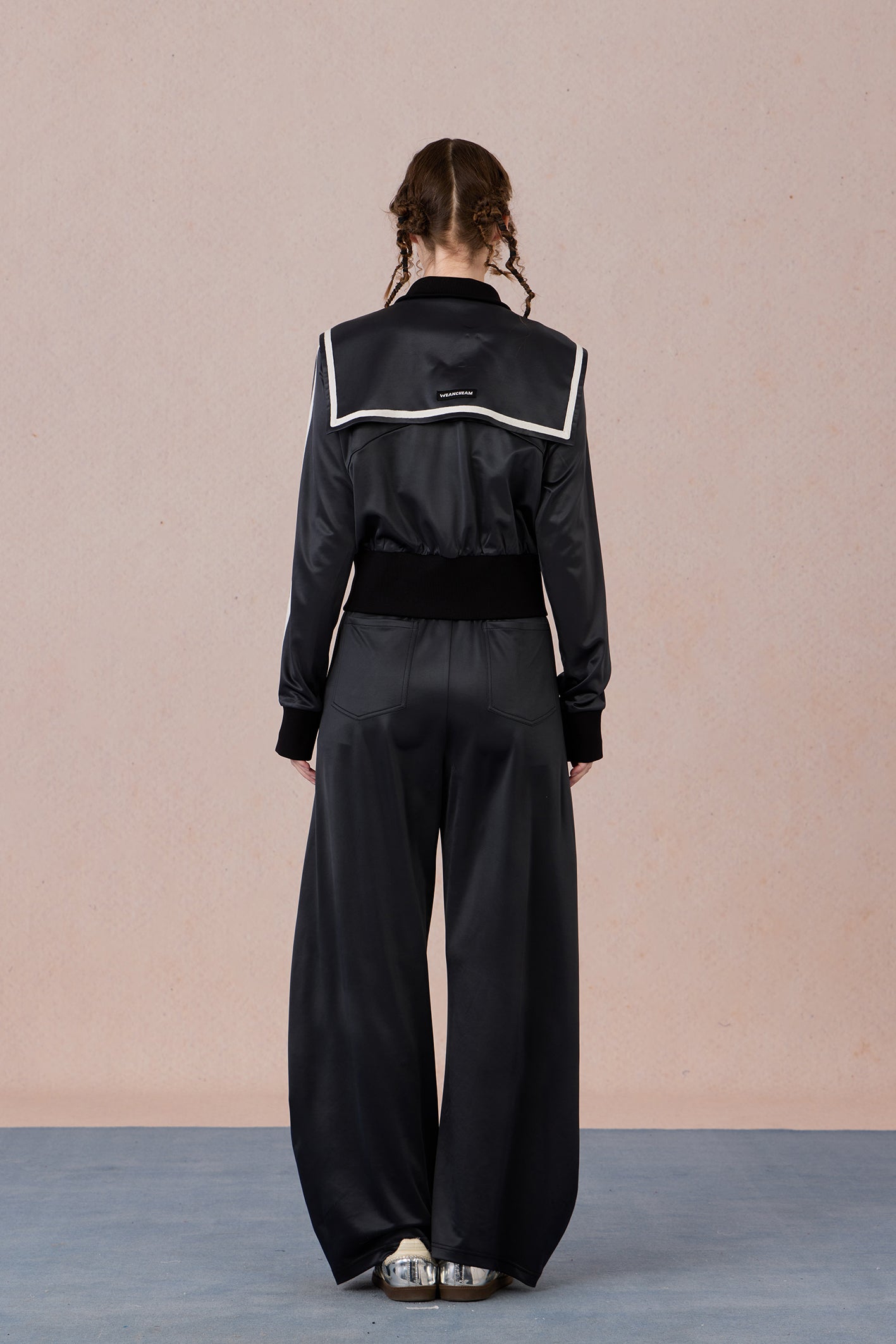  Back view of tailored color-block jacket with fitted waistline and sporty trim