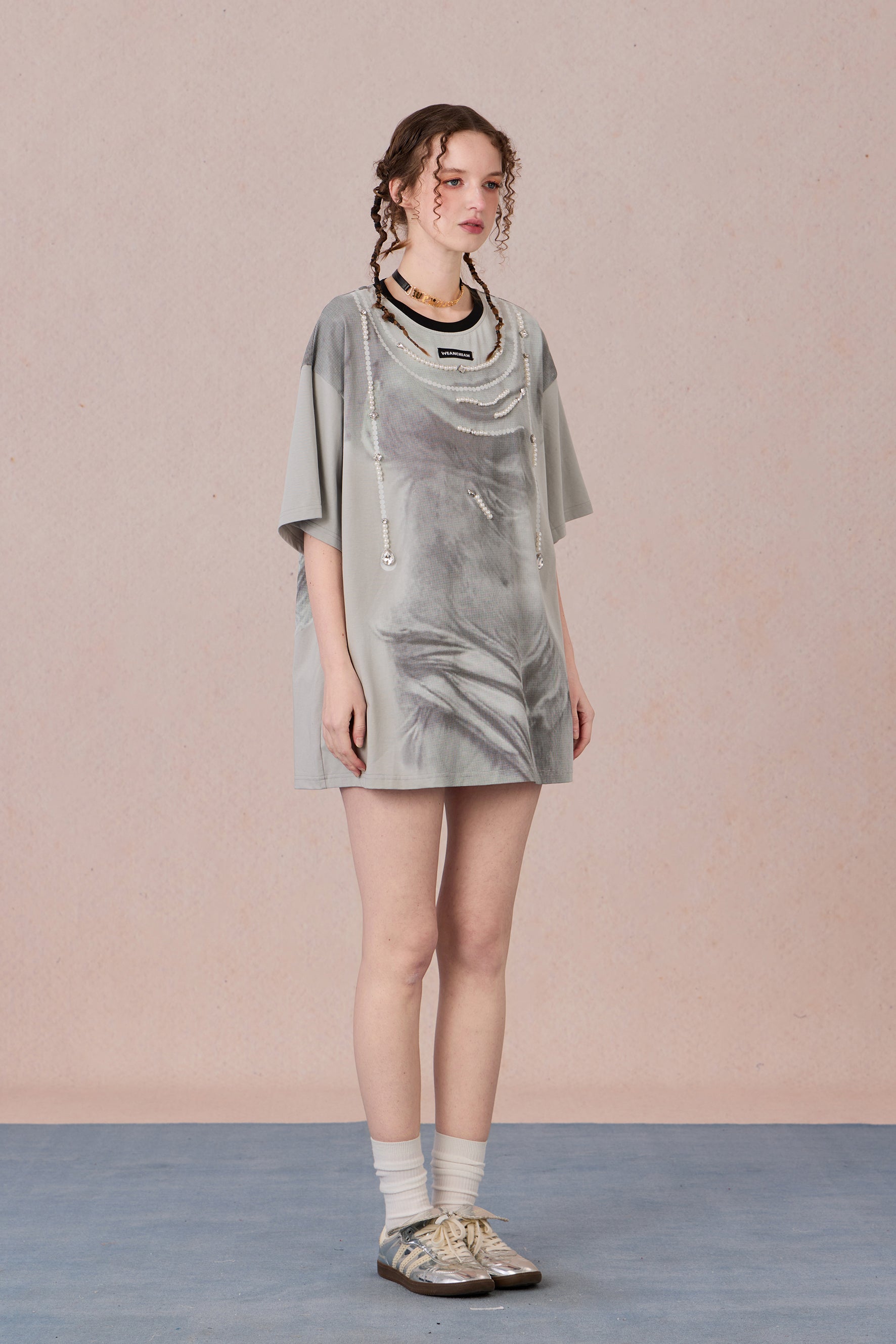 Louvre-inspired pixelated statue graphic with hand-sewn embellishments
